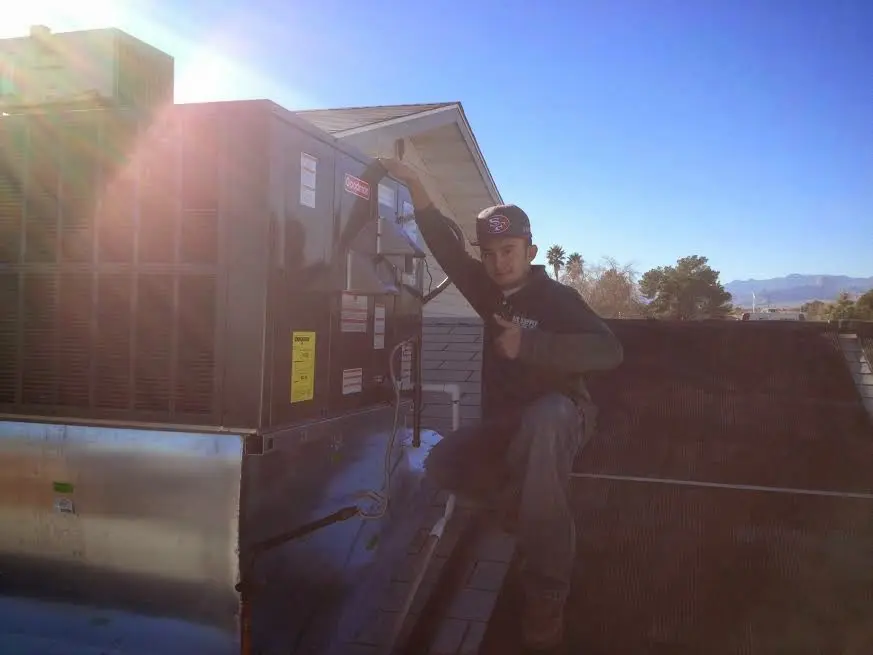 HVAC technician performing Boiler Repair on a rooftop unit in Pocahontas